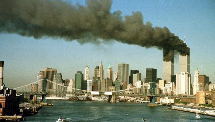 A September 11, 2001 file photo shows the towers of New York's World Trade Center pour smoke shortly after being struck by hijacked commercial aircraft. New York City plans to mark the third anniversary of the attacks on the trade center with an observance at the site on September 11 with parents and grandparents of victims reading their names. REUTERS/Brad Rickerby  JDP