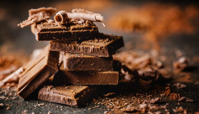 Closeup of dark chocolate bars and cocoa powder.
