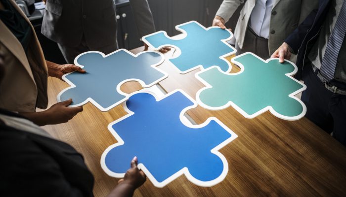 Business people connecting puzzle pieces
