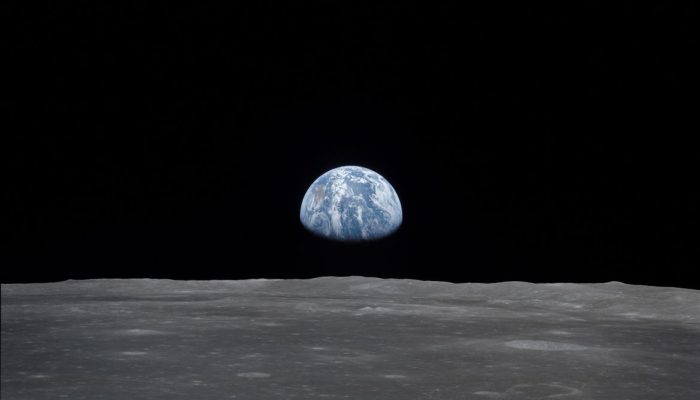View of Moon limb with Earth on the horizon,Mare Smythii Region. Earth rise. This image was taken before separation of the LM and the Command Module during Apollo 11 Mission. Original film magazine was labeled V. Film Type: S0-368 Color taken with a 250mm lens.  Approximate photo scale 1:1,300,000. Principal Point Latitude was 3 North by Longitude 85 East. Foward overlap is 90%. Sun angle is High. Approximate Tilt minimum is 65 degrees,maximum is 69. Tilt direction is West (W).