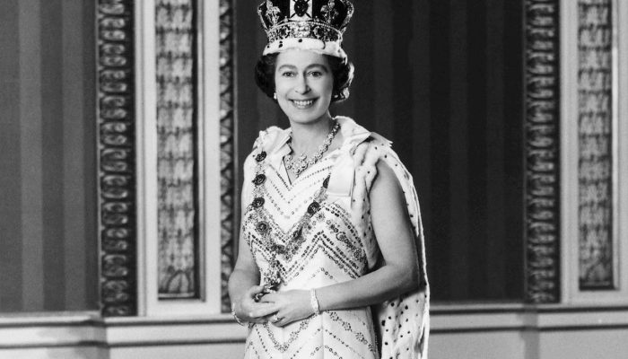 The Queen Elizabeth II, dressed in royal regalia, posed for this special Jubilee picture in the Throne Room of Buckingham Palace, after she had delivered the traditional Queen's speech at the 1976 official State Opening of Parliament. She wears the Imperial State Crown and the Robe of State, also known as the Parliamentary Robe. Around her neck is the Jubilee Necklace of diamonds and pearls and the chain is the Collar of the Order of the Garter, Britain's premier order of Knighthood. Her gown is of white silk with bands of gold and silver embroidery. (Photo credit should read /AFP/Getty Images)