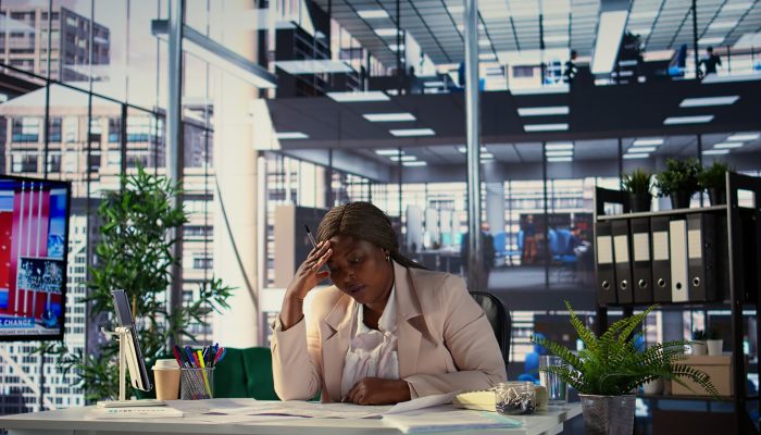 African american businesswoman searching for commercial office spaces, doing a blueprints review and drafting building layouts to find the perfect property. Investment strategy real estate. Camera B.