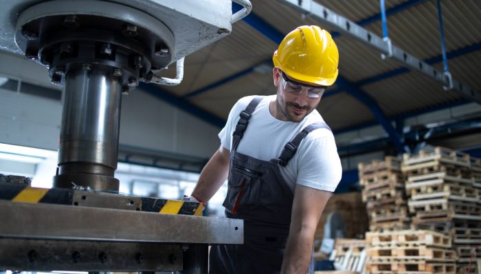 factory-employee-working-industrial-drilling-machine-production-line