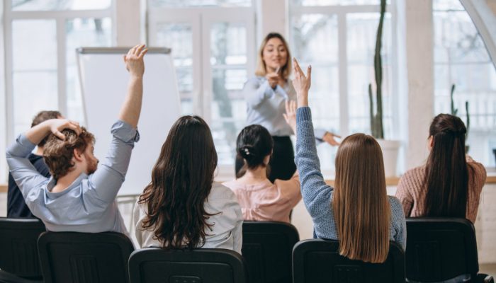 female-speaker-giving-presentation-hall-university-workshop-audience-conference-hall
