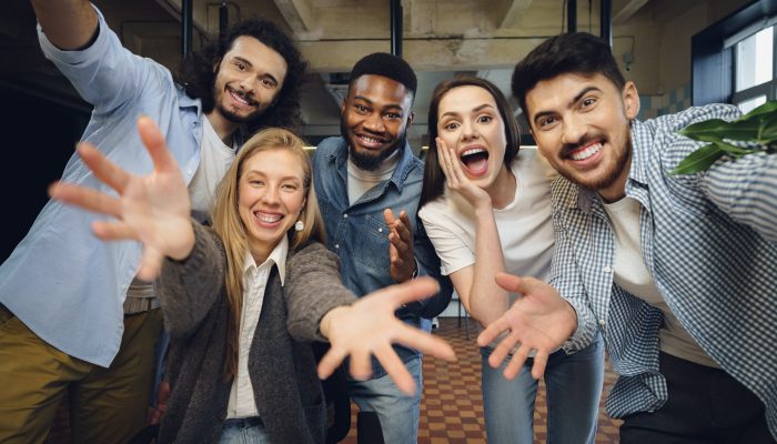 Happy overjoyed business team celebrate corporate victory in their office