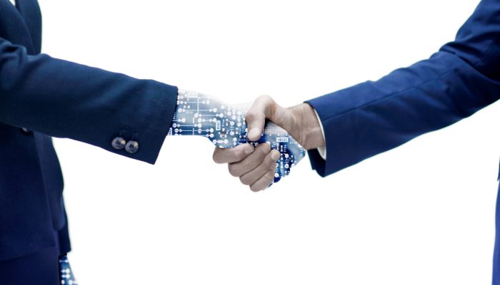 man-shaking-hand-with-robotic-arm
