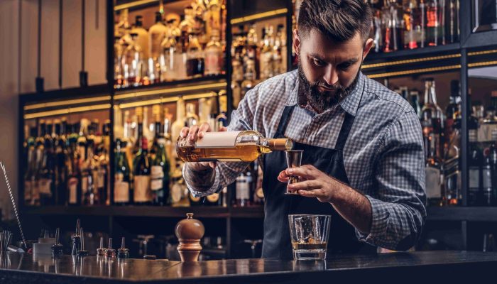 stylish-brutal-bartender-shirt-apron-makes-cocktail-bar-counter-background