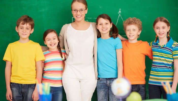 teacher-students-standing-front-blackboard